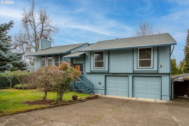 bi-level home featuring driveway, a garage, a chimney, and stairway