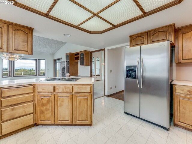 2221 NW 206th St, Ridgefield, WA 98642 - kitchen with stainless steel fridge with ice dispenser, stovetop, vaulted ceiling, light countertops, and a chandelier