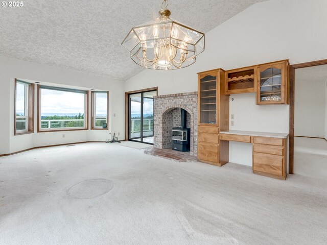 2221 NW 206th St, Ridgefield, WA 98642 - unfurnished living room with light carpet, a textured ceiling, a chandelier, a desk, and a wood stove