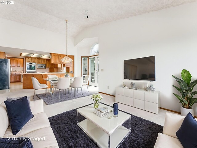 2221 NW 206th St, Ridgefield, WA 98642 - living area featuring baseboards and high vaulted ceiling