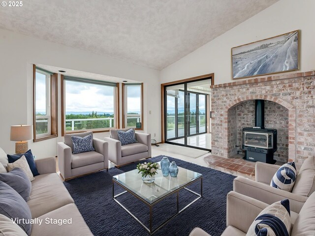 2221 NW 206th St, Ridgefield, WA 98642 - living room featuring a wood stove, lofted ceiling, a textured ceiling, and plenty of natural light