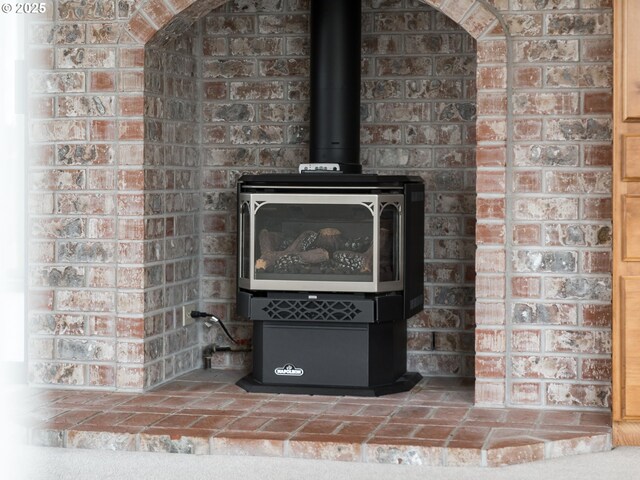 2221 NW 206th St, Ridgefield, WA 98642 - detailed view of a wood stove and brick wall