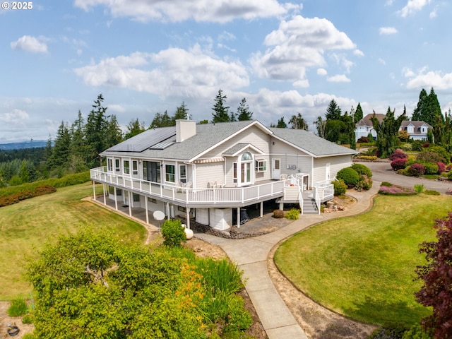 2221 NW 206th St, Ridgefield, WA 98642 - back of house featuring a wooden deck, a lawn, and a shingled roof