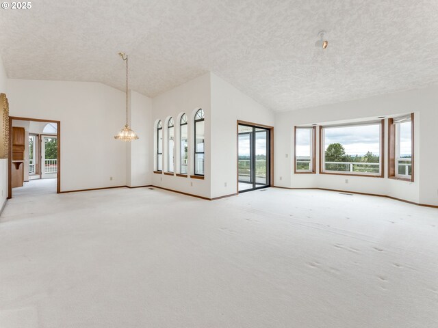 2221 NW 206th St, Ridgefield, WA 98642 - spare room featuring vaulted ceiling, a chandelier, a textured ceiling, and light carpet