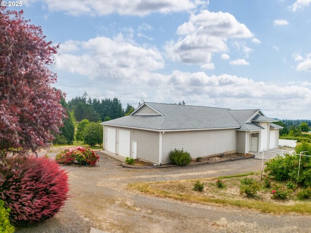 2221 NW 206th St, Ridgefield, WA 98642 - view of property exterior featuring driveway and roof with shingles