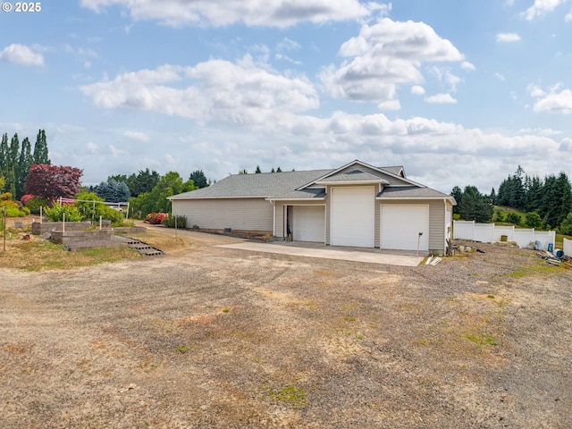 2221 NW 206th St, Ridgefield, WA 98642 - view of front of house featuring an attached garage, a vegetable garden, and driveway