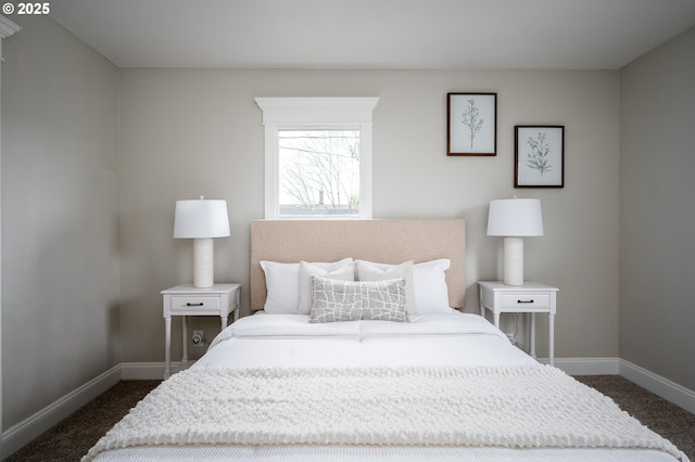 bedroom with baseboards and dark carpet