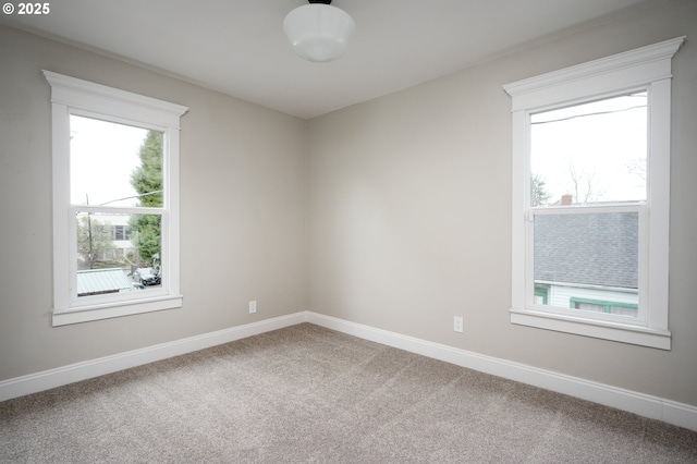 unfurnished room with baseboards and carpet