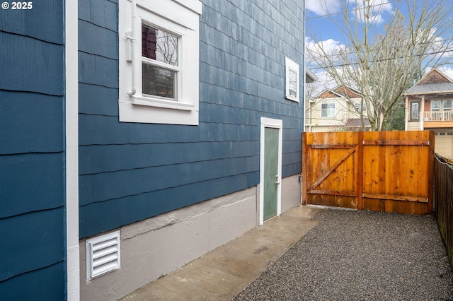 view of side of property featuring a gate and fence