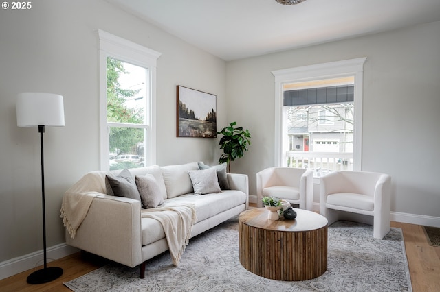 living area with wood finished floors and baseboards