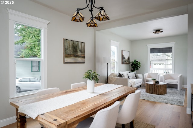 dining room with hardwood / wood-style flooring and baseboards