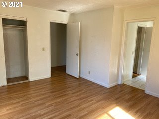 unfurnished bedroom with hardwood / wood-style floors and a closet