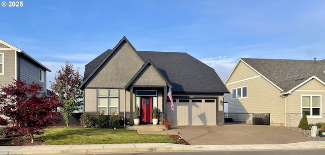 craftsman-style home featuring concrete driveway, a front lawn, an attached garage, and fence