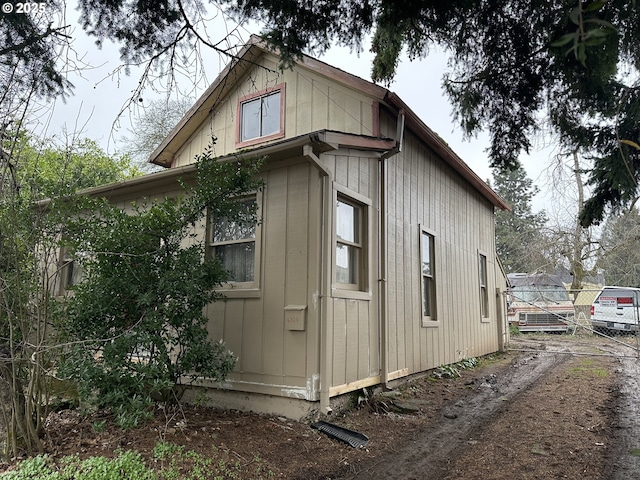 view of side of home with fence