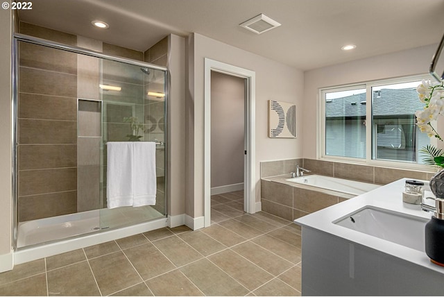 bathroom featuring shower with separate bathtub, tile floors, and sink