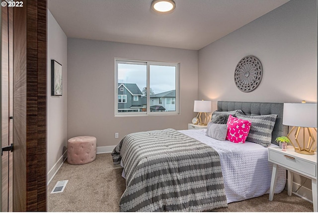 bedroom with dark colored carpet