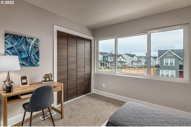 bedroom featuring a closet and light carpet