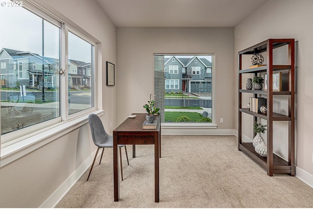 carpeted home office featuring plenty of natural light