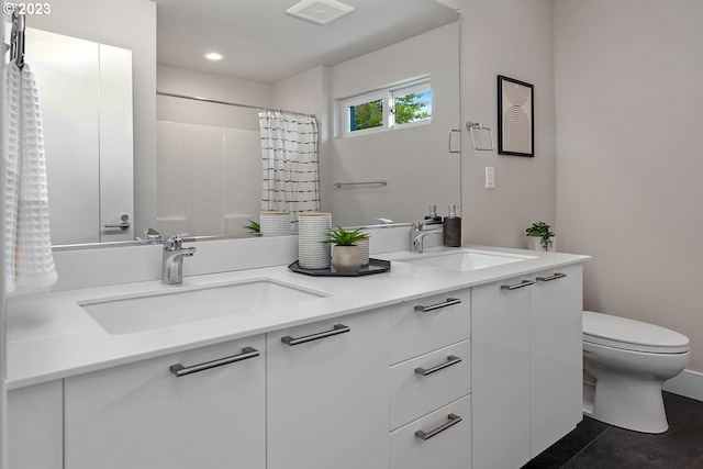 bathroom featuring double sink, tile flooring, oversized vanity, and toilet