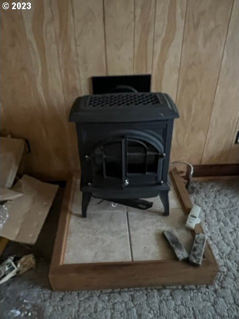 interior details featuring wood walls and a wood stove