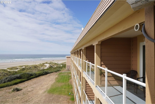 exterior space featuring a view of the beach and a water view