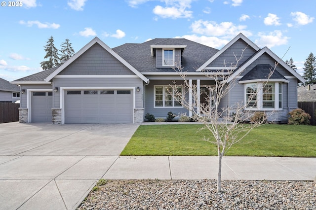 craftsman inspired home featuring a garage, concrete driveway, fence, and a front lawn