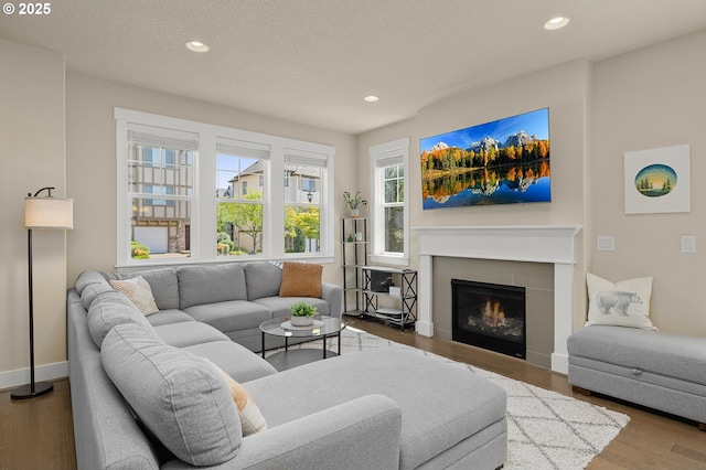 13193 SW Aubergine Ter, Sherwood, OR 97140 - living area featuring recessed lighting, wood finished floors, a tile fireplace, and a textured ceiling