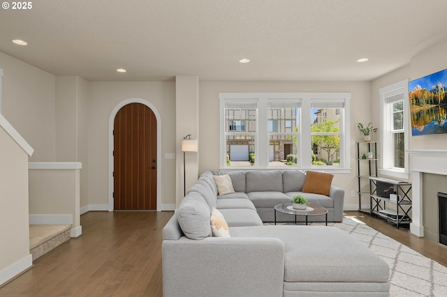 13193 SW Aubergine Ter, Sherwood, OR 97140 - living area with arched walkways, wood finished floors, recessed lighting, and a fireplace