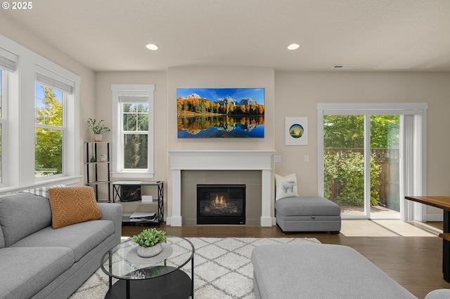 13193 SW Aubergine Ter, Sherwood, OR 97140 - living room with wood finished floors, recessed lighting, and a tiled fireplace