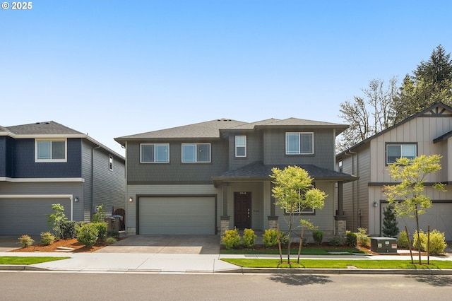 view of front of house with concrete driveway, an attached garage, and cooling unit
