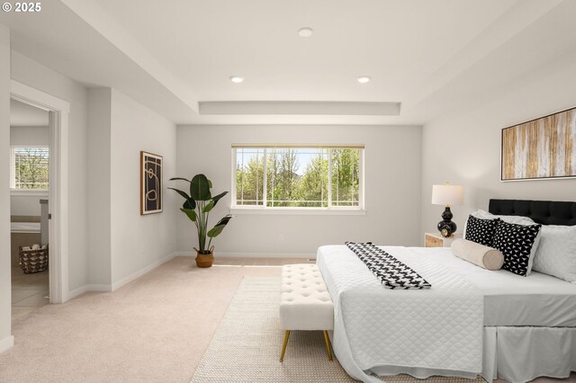 carpeted bedroom with baseboards, recessed lighting, and a raised ceiling
