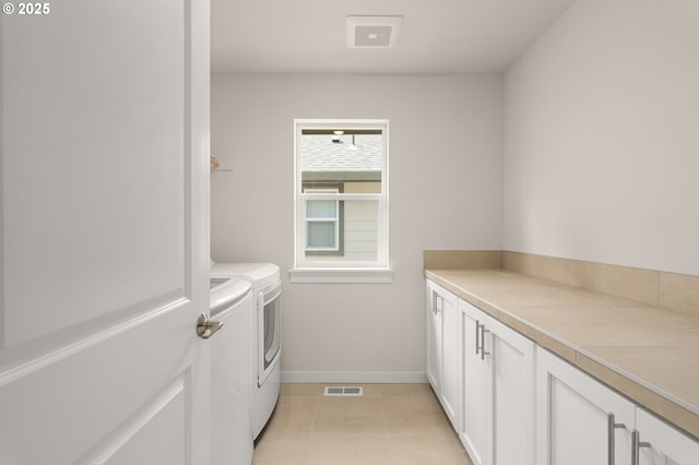 16648 SW Colorado Ln, Tigard, OR 97224 - laundry room with cabinet space, independent washer and dryer, baseboards, and light tile patterned flooring