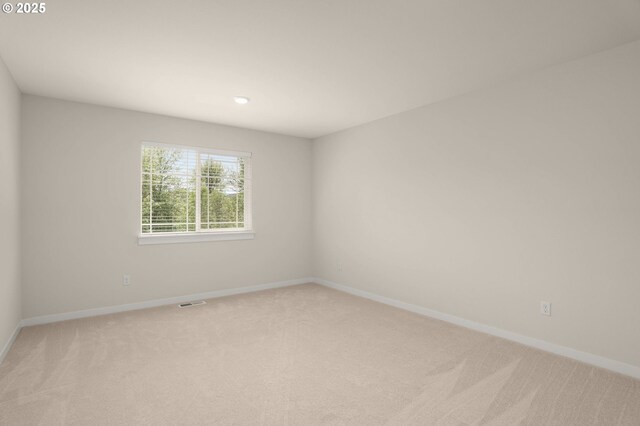empty room with recessed lighting, baseboards, and light carpet