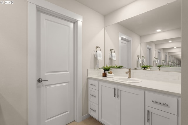 16648 SW Colorado Ln, Tigard, OR 97224 - bathroom with vanity, backsplash, recessed lighting, and baseboards