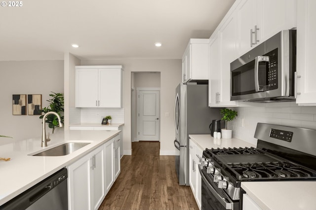 16648 SW Colorado Ln, Tigard, OR 97224 - kitchen featuring stainless steel appliances, a sink, white cabinetry, light countertops, and recessed lighting