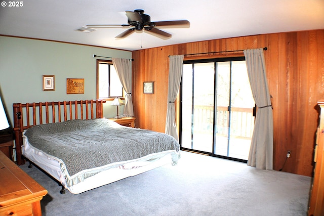 924 Lou Gray Dr, Myrtle Creek, OR 97457 - carpeted bedroom with wood walls, access to exterior, ornamental molding, and a ceiling fan