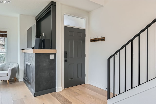 5036 SW View Point Ter, Portland, OR 97239 - entryway featuring light wood finished floors and a fireplace