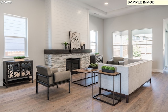 8119 N Hargrave St, Camas, WA 98607 - living area featuring a stone fireplace, baseboards, wood finished floors, and recessed lighting