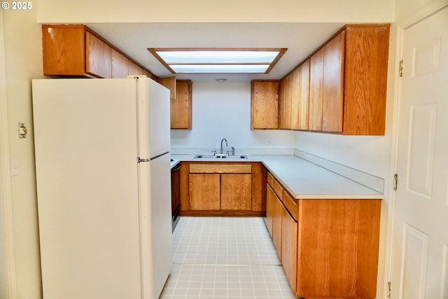 1680 22nd St, Florence, OR 97439 - kitchen with freestanding refrigerator, light countertops, and brown cabinetry