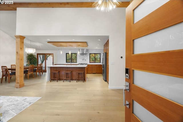3520 Red Cedar Way, Lake Oswego, OR 97035 - kitchen featuring wall chimney range hood, freestanding refrigerator, light wood-style flooring, light countertops, and recessed lighting