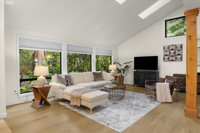 3520 Red Cedar Way, Lake Oswego, OR 97035 - living room featuring plenty of natural light, a skylight, high vaulted ceiling, and wood finished floors
