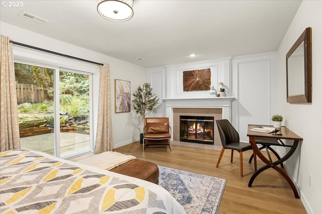 3520 Red Cedar Way, Lake Oswego, OR 97035 - bedroom featuring access to outside, light wood-type flooring, a tiled fireplace, and recessed lighting