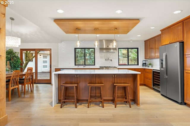 3520 Red Cedar Way, Lake Oswego, OR 97035 - kitchen with appliances with stainless steel finishes, wine cooler, range hood, brown cabinets, and recessed lighting