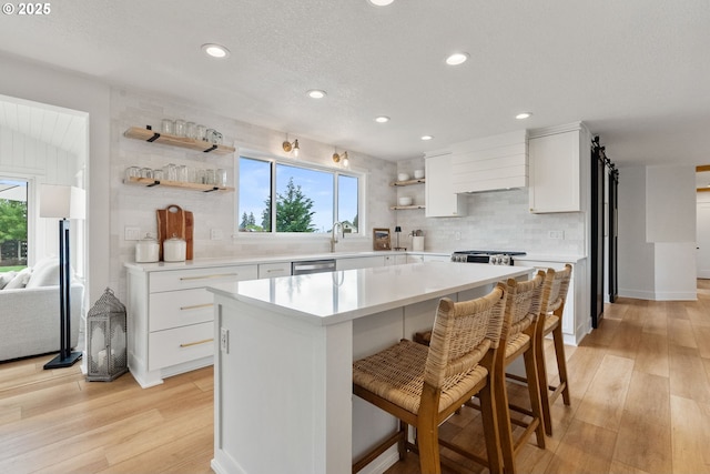 kitchen with tasteful backsplash, open shelves, and light wood-style flooring