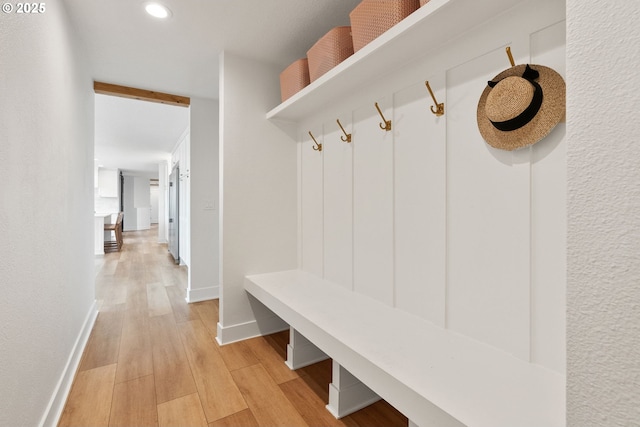 mudroom featuring recessed lighting, baseboards, and light wood-style floors