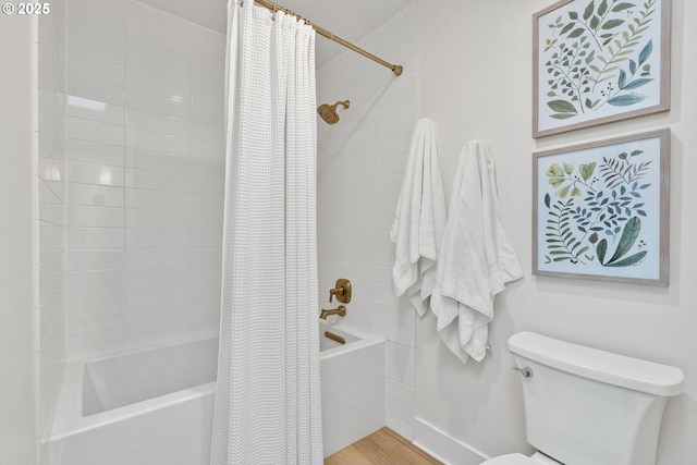 full bath featuring wood finished floors, shower / bath combo, and toilet