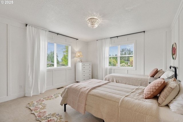 bedroom featuring a decorative wall and multiple windows