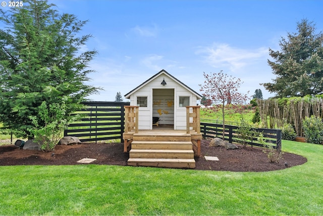 exterior space featuring fence and an outbuilding