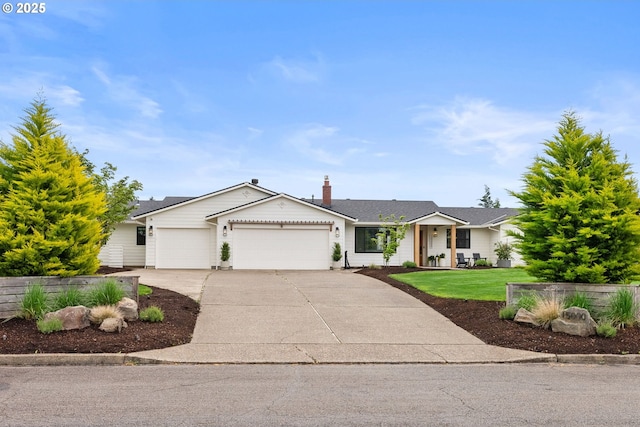 ranch-style house featuring an attached garage, concrete driveway, and a front yard