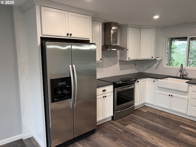 891 NE Bunyard Pl, Estacada, OR 97023 - kitchen with appliances with stainless steel finishes, wall chimney range hood, dark countertops, dark wood-style flooring, and a sink